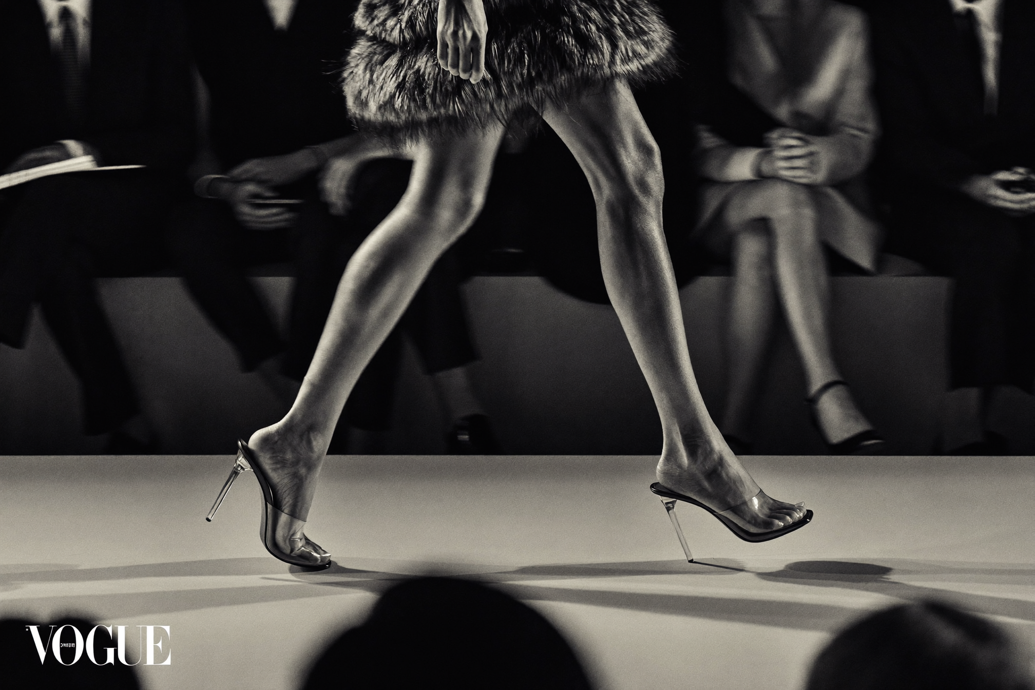 Model wearing clear jelly kitten heel mules on a luxury fashion week runway